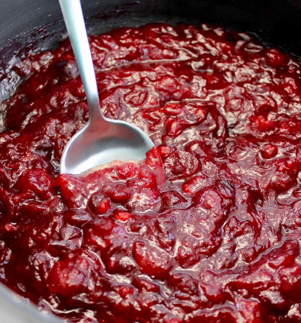 Keto Cranberry Sauce in saucepan with spoon
