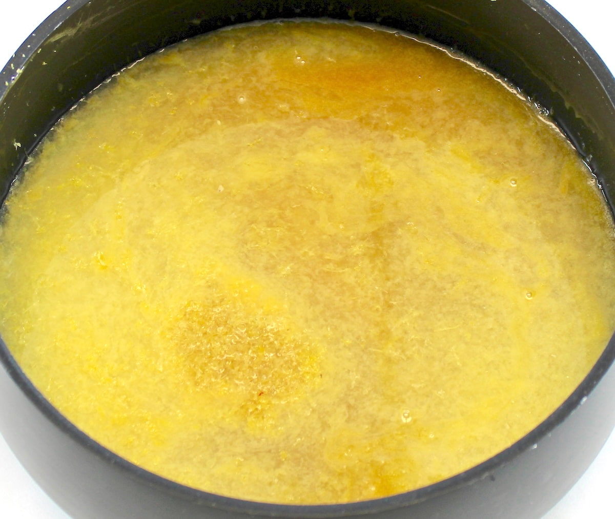 Keto Lemon Curd in saucepan cooking