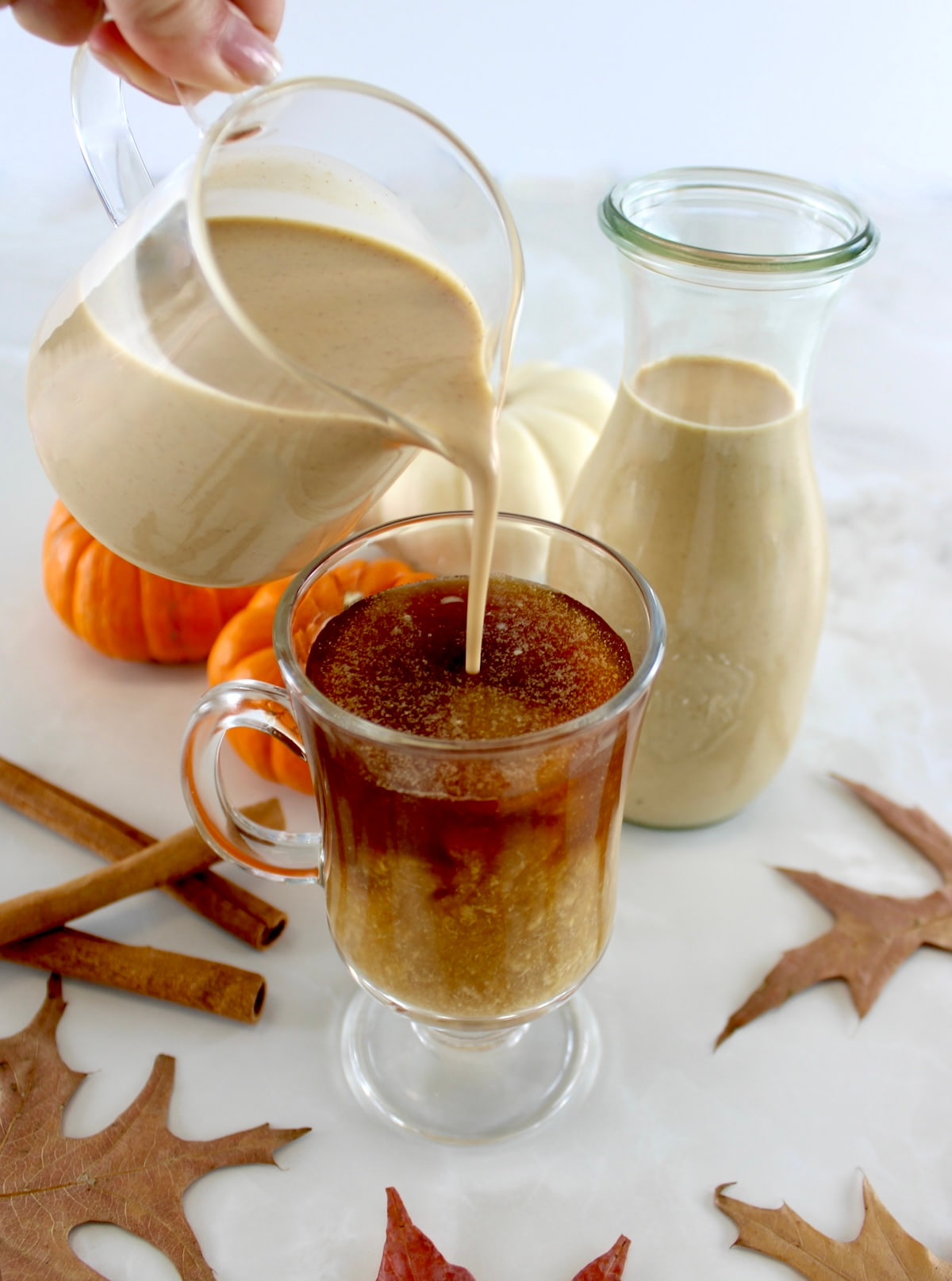 Keto Pumpkin Spice Coffee Creamer being poured into coffee in glass