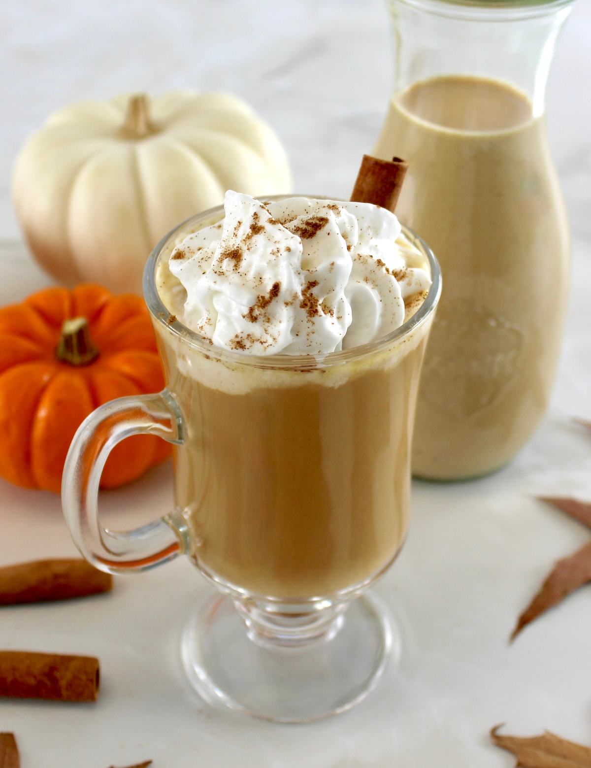 coffee in glass with Keto Pumpkin Spice Coffee Creamer and whip cream on top