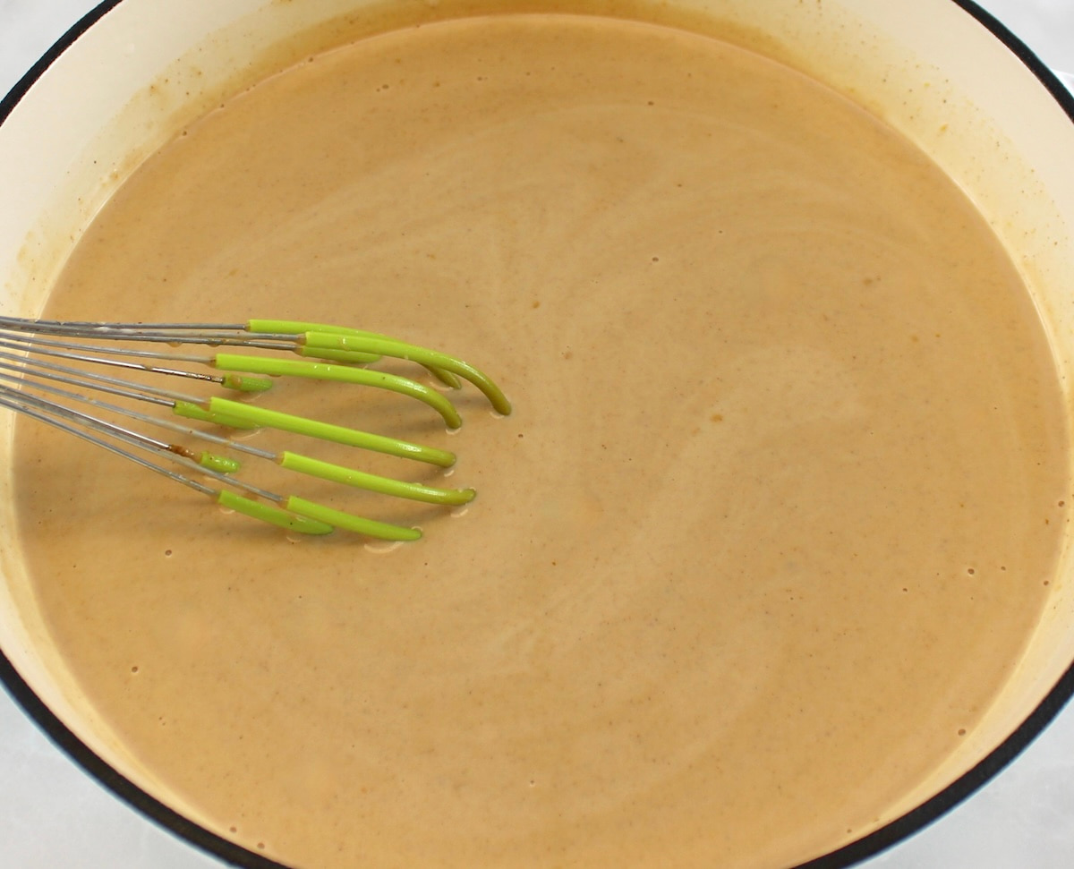 Keto Pumpkin Spice Coffee Creamer in white skillet with whisk