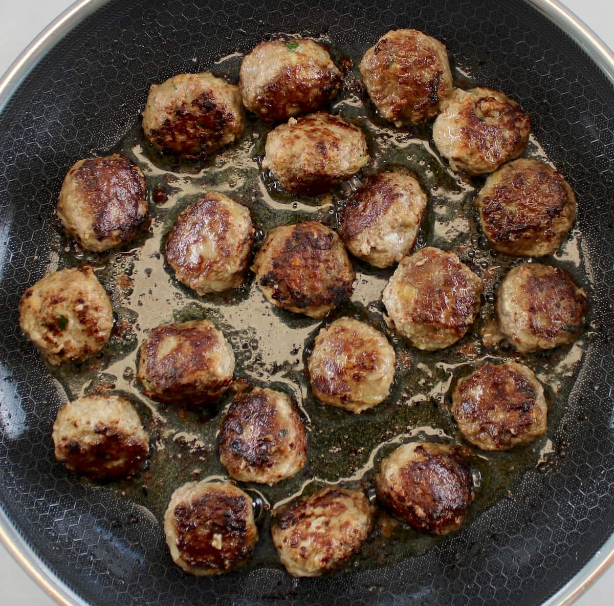Keto Swedish Meatballs frying in skillet