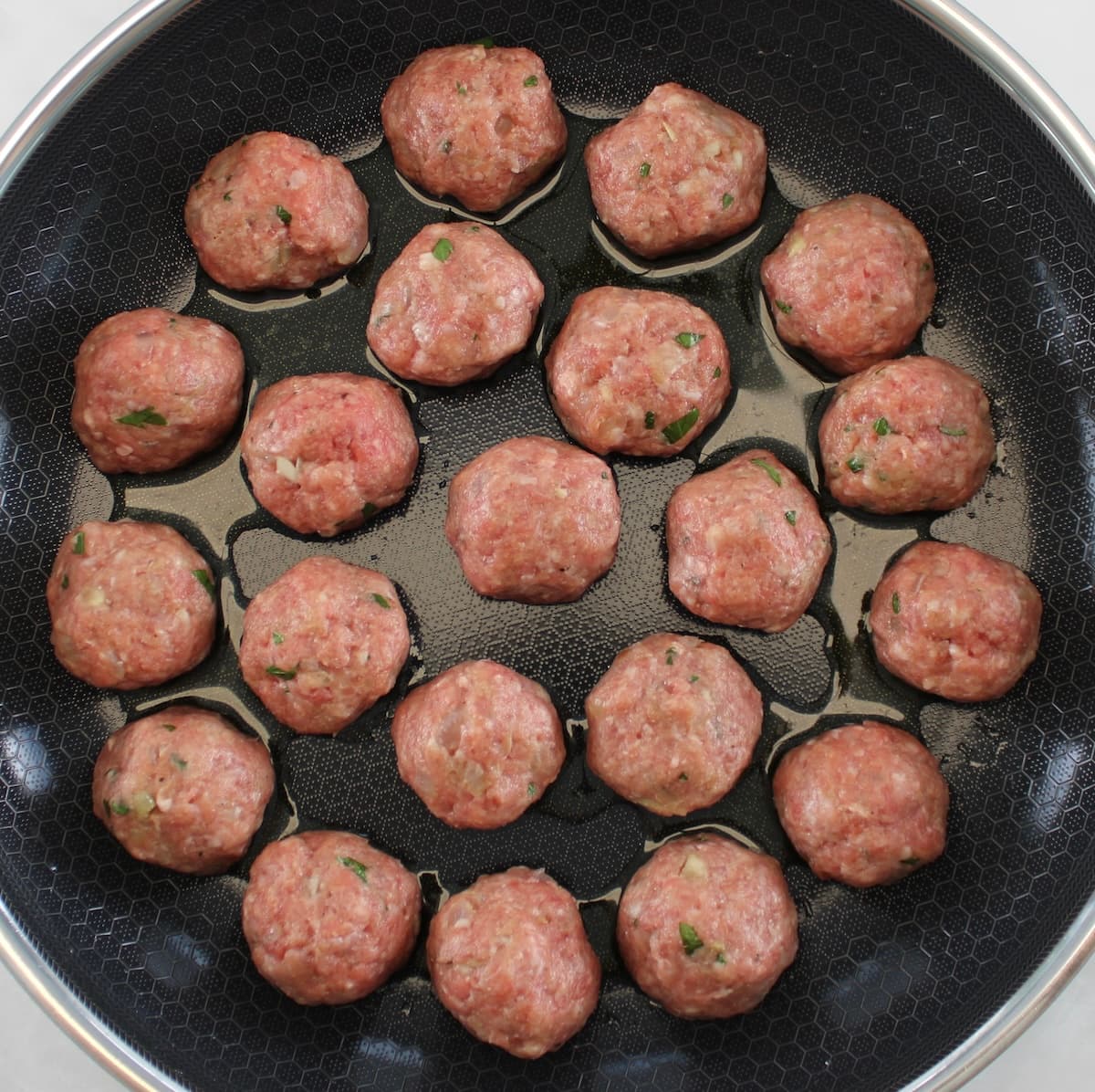 Keto Swedish Meatballs frying in skillet