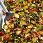 Roasted Balsamic Brussels Sprouts with Prosciutto on baking sheet with spatula