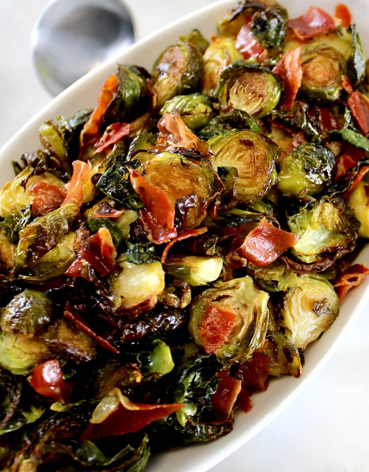 closeup of Roasted Balsamic Brussels Sprouts with Prosciutto in white bowl