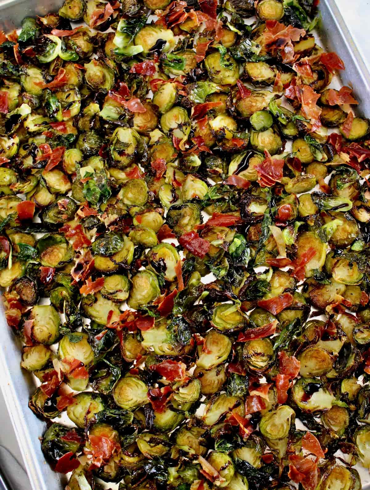 overhead view of Roasted Balsamic Brussels Sprouts with Prosciutto on baking sheet